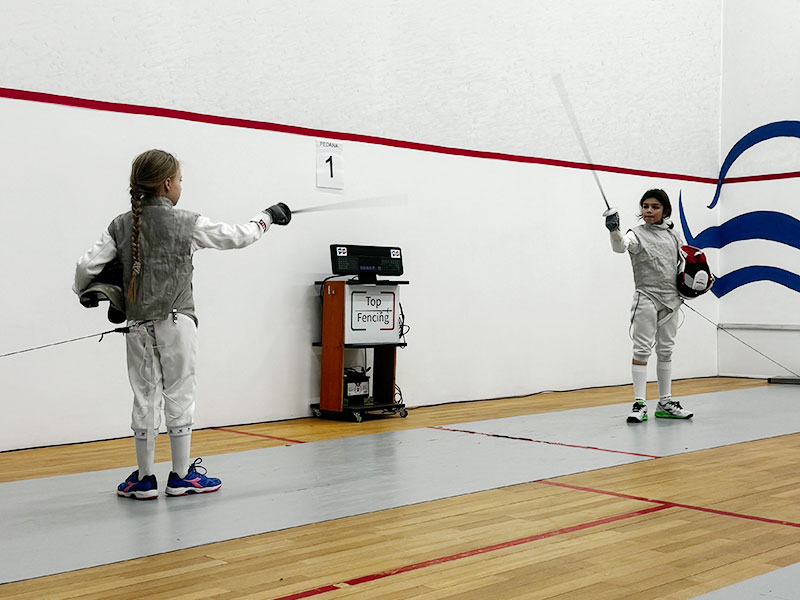 Bambini partecipano a una lezione di scherma in una palestra di Milano